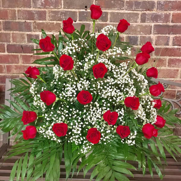 Large arrangement of red roses and white baby's breath