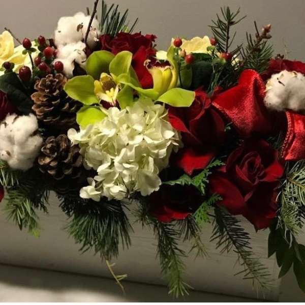Red roses and white flowers arranged in a rectangular container