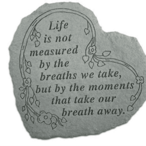 Gray stone plaque with a floral quote and vine illustration