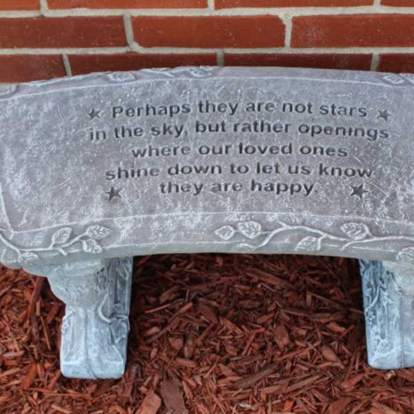 Stone memorial bench with an engraved quote