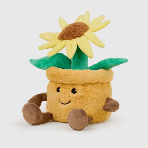 Plush sunflower toy with a smiling face and green leaves