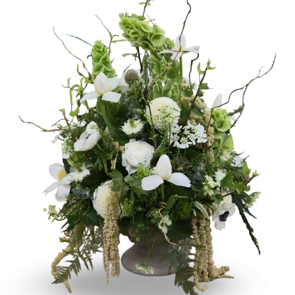 Tall white and green floral arrangement in a pedestal vase