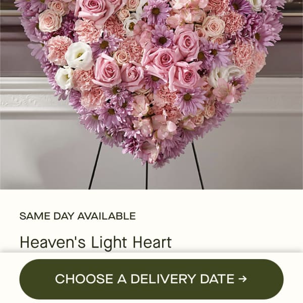 Heart-shaped pink and lavender floral arrangement on an easel