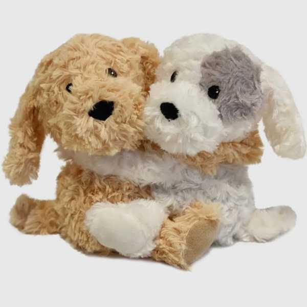 Two plush dog toys sitting together on a white background
