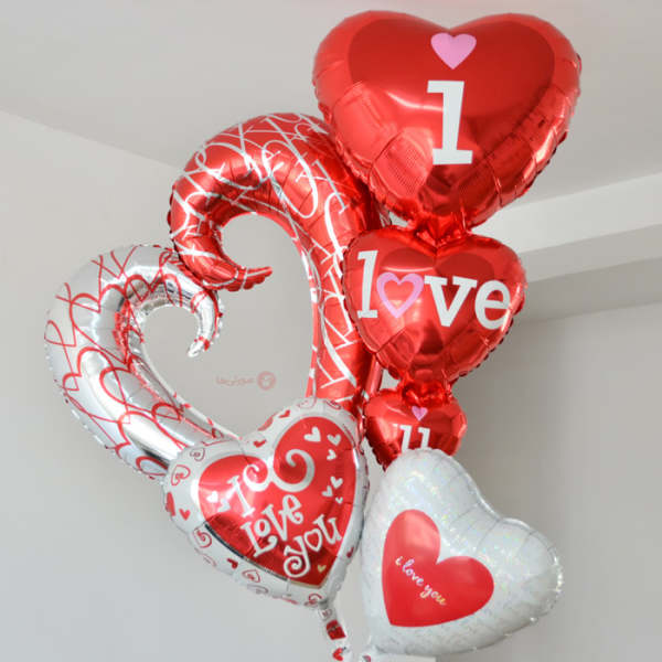 Cluster of heart-shaped red and white balloons with love messages