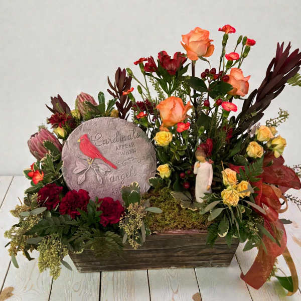 Mixed floral arrangement with a cardinal memorial stone in a wooden planter