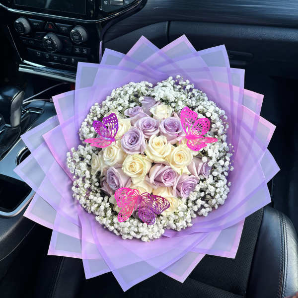 Lavender and cream rose bouquet with baby’s breath and pink butterfly picks