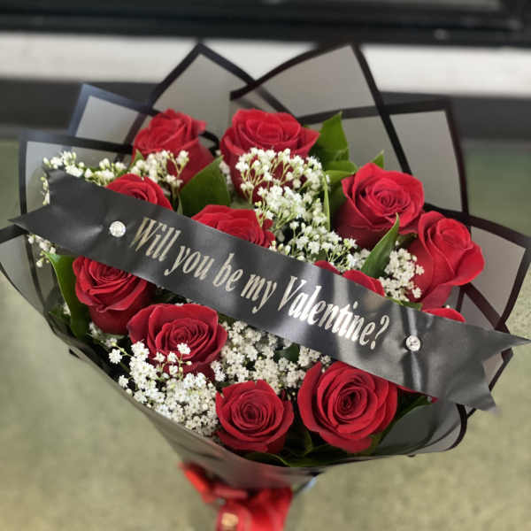 Bouquet of red roses with a Valentine ribbon