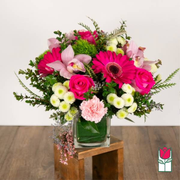 Pink and white mixed flower arrangement in a glass vase