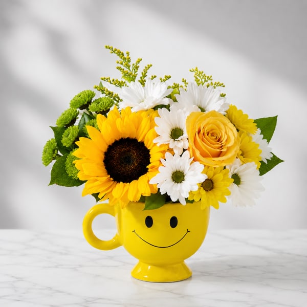 Bouquet of sunflowers, daisies, and a yellow rose in a smiley-face mug