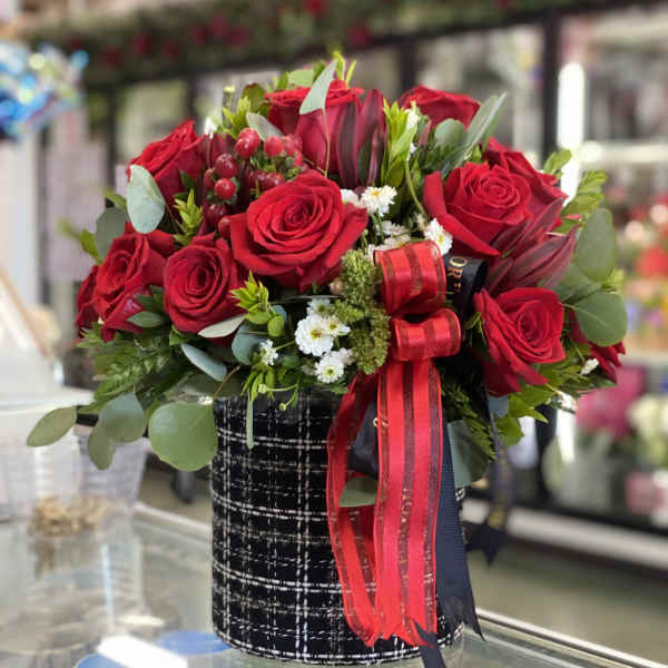 Red rose bouquet in a black patterned box with ribbon