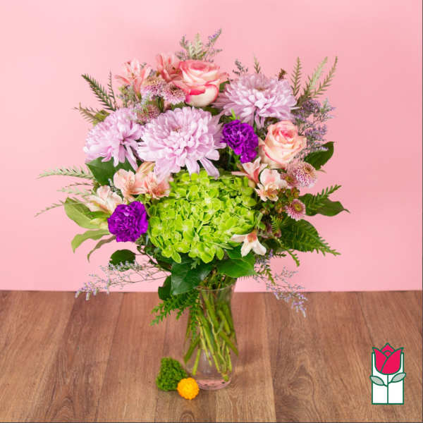Bouquet of pink and purple flowers in a clear glass vase