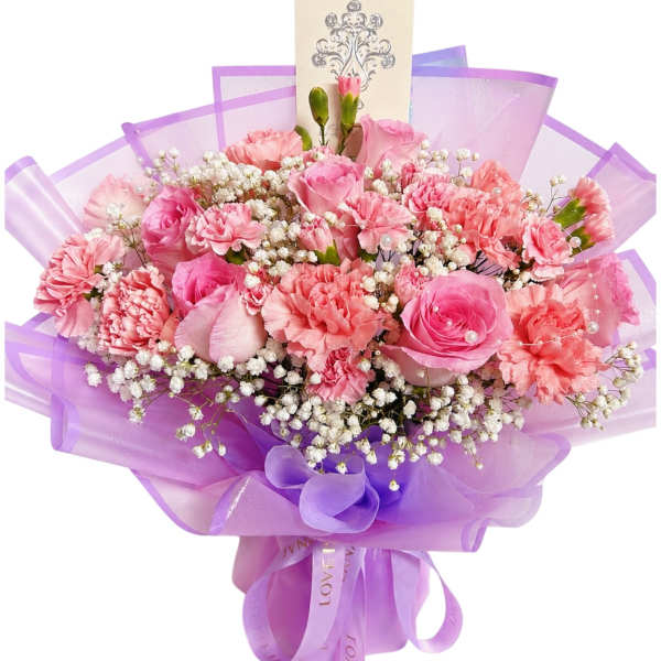 Pink roses and carnations in purple wrapping with baby's breath