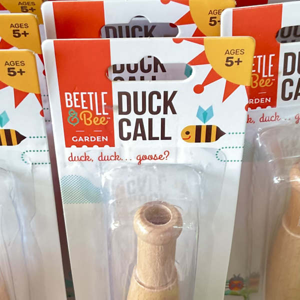 Packaged wooden duck call toy with Beetle & Bee Garden branding
