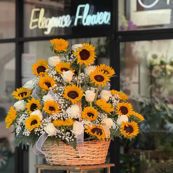 Basket arrangement of sunflowers and white roses