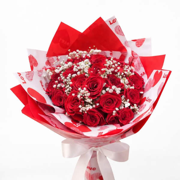 Bouquet of red roses with white baby's breath in heart-patterned wrapping