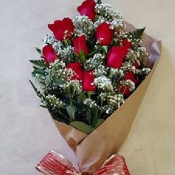 Bouquet of red roses wrapped in brown paper with a red ribbon