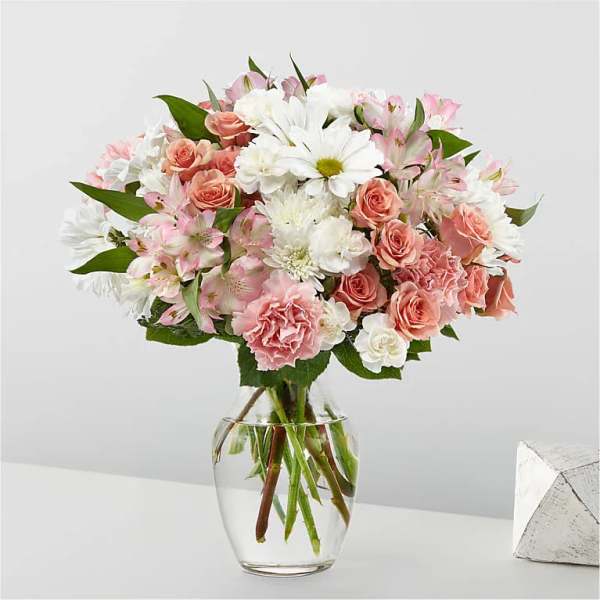 Pink and white mixed bouquet in a clear glass vase