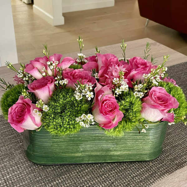 Pink roses and green moss in a rectangular green container