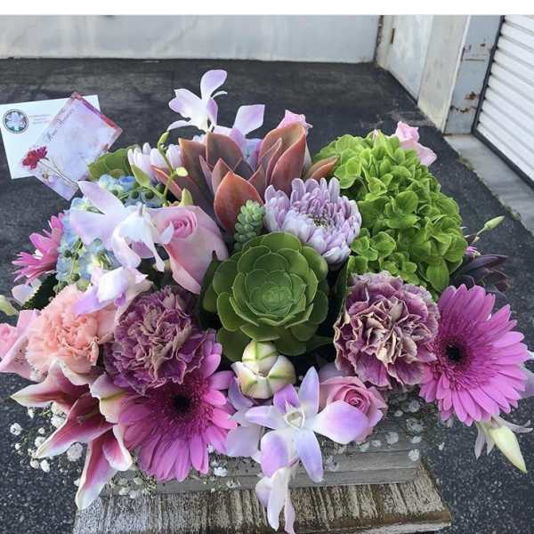 Mixed bouquet with pink, purple, and green flowers and succulents