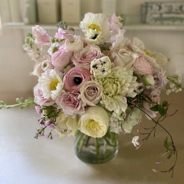 Soft pink and white bouquet in a glass vase
