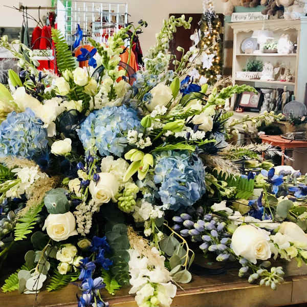 Large blue and white floral arrangement on a table