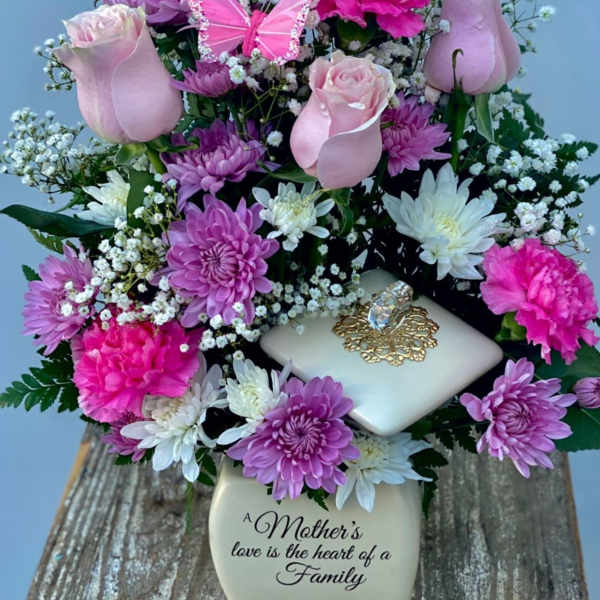 Pink roses, chrysanthemums, and carnations in a decorative vase