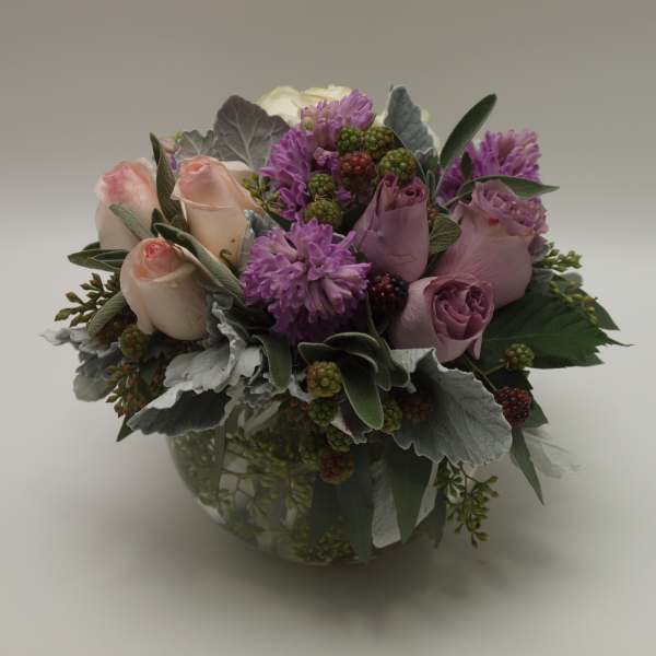 Bouquet of pink and lavender roses in a glass vase