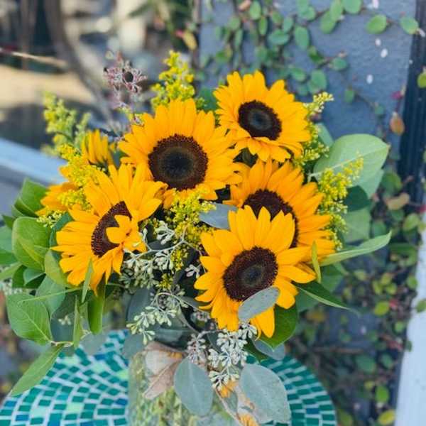 Bouquet of yellow sunflowers in a glass vase