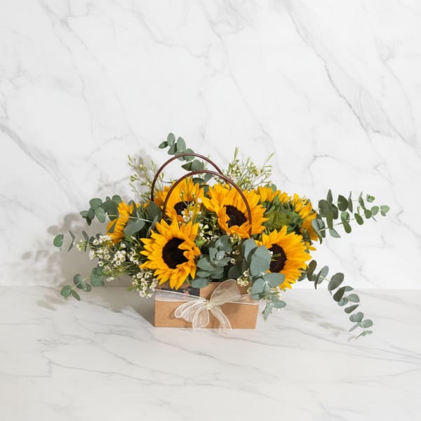Sunflower arrangement in a kraft box with a ribbon