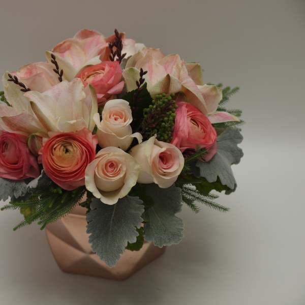 Pink and cream mixed flower arrangement in a copper vase