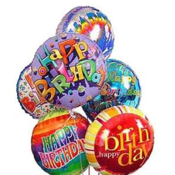 Cluster of colorful birthday balloons with printed messages