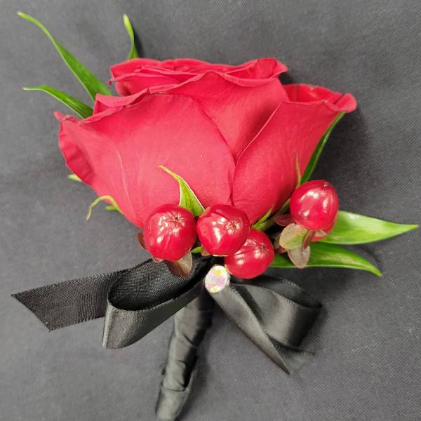 Red rose boutonniere with berries and black ribbon