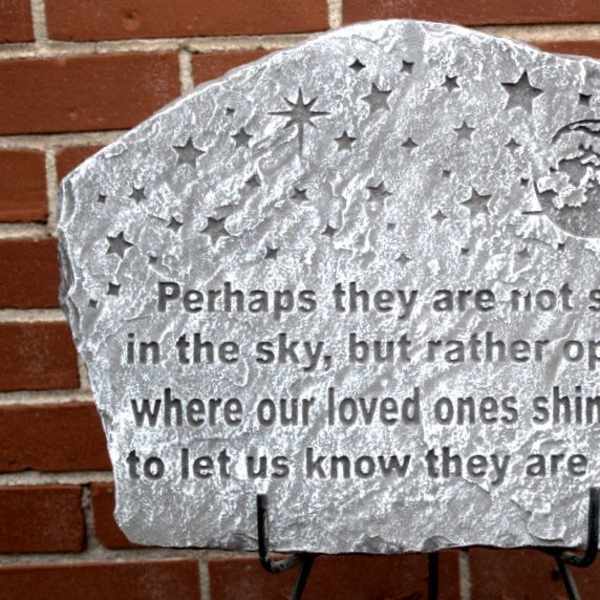 Stone memorial plaque with an engraved quote and stars