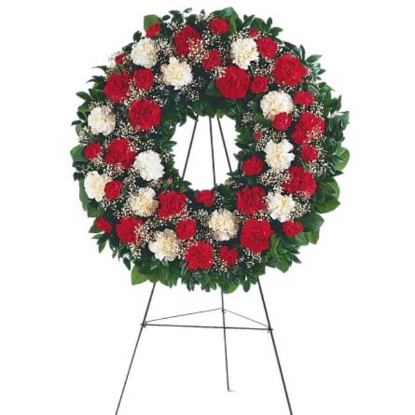 Red and white floral wreath on a standing easel