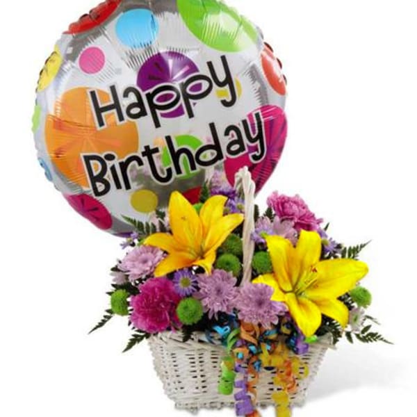 Birthday balloon above a basket of colorful flowers