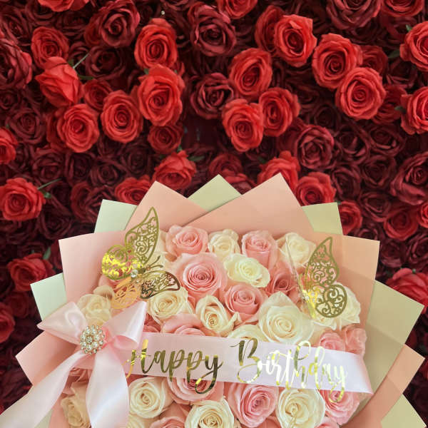 Pink and cream rose bouquet with a Happy Birthday ribbon