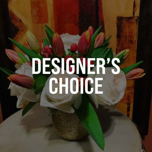 Bouquet of white roses and pink tulips in a glittery vase