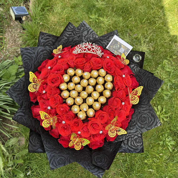 Heart-shaped bouquet of red roses with gold-wrapped chocolates and a birthday topper