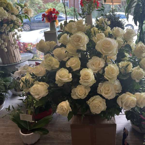 Large bouquet of cream roses arranged in a box