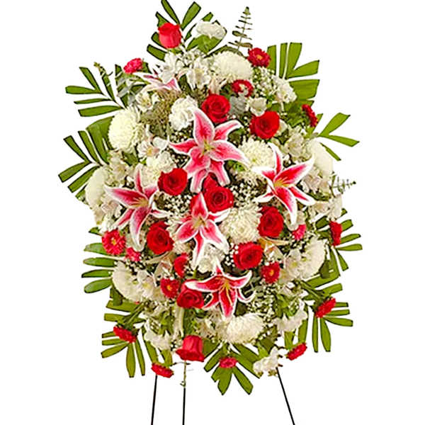 Standing funeral spray with red roses, pink lilies, and white flowers