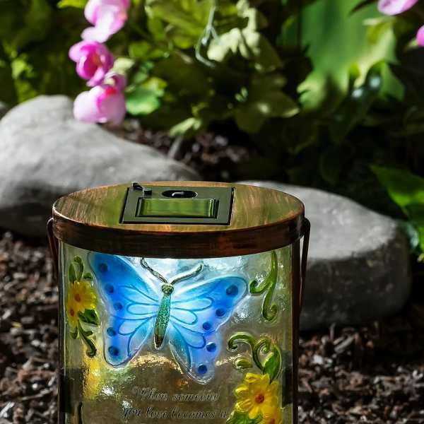 Butterfly memorial lantern with floral accents and a quote