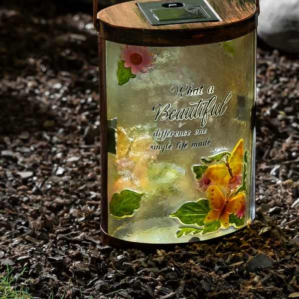 Decorative solar lantern with butterfly and flower accents