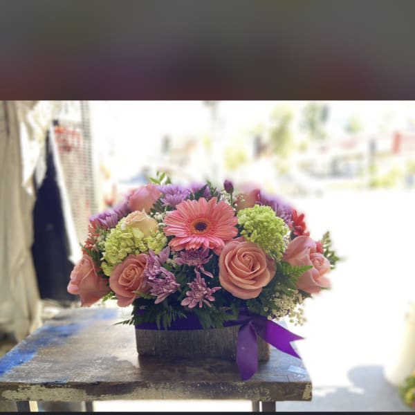 Beautiful pastel arrangement in a wood material
