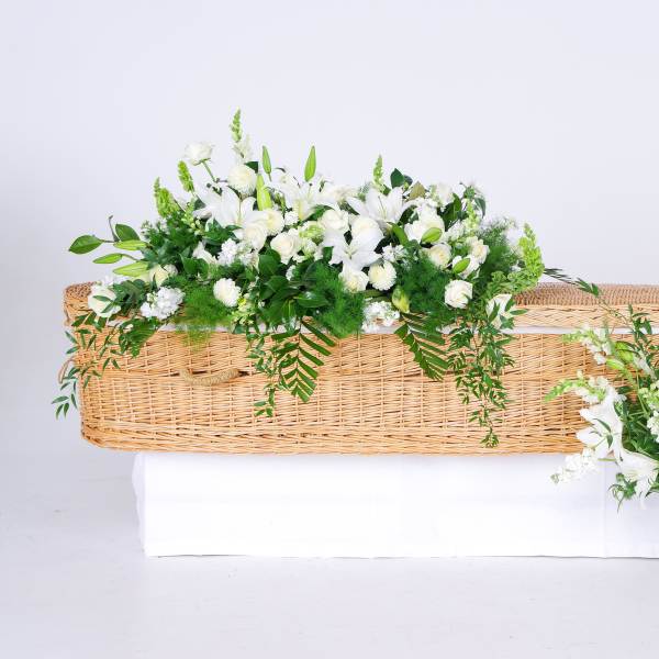 White floral casket spray with a matching vase arrangement