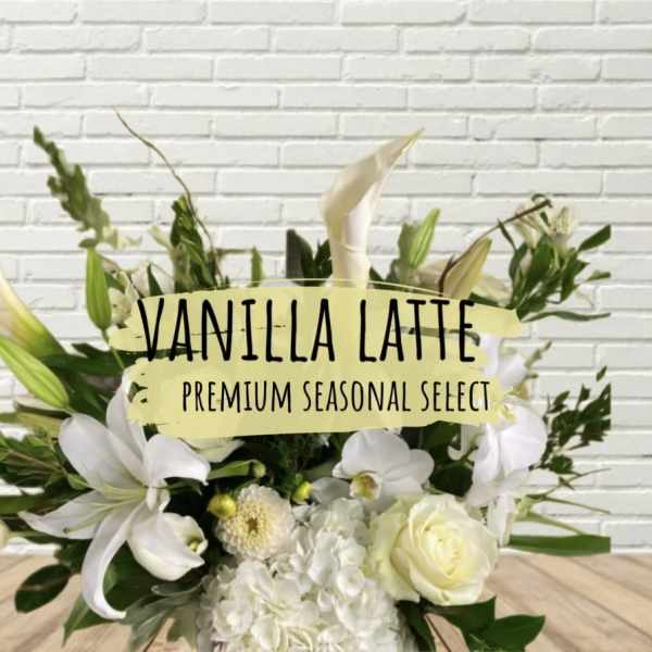 White floral arrangement with lilies, roses, and orchids
