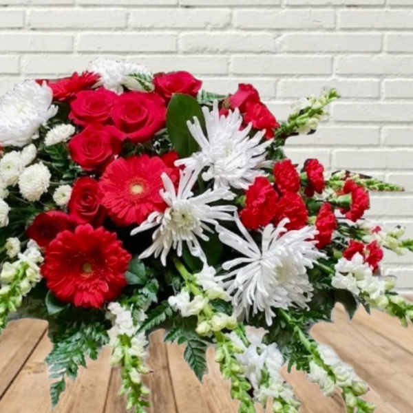 Red and white mixed flower arrangement with daisies and roses