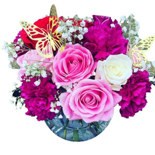 Pink and white roses with magenta carnations in a glass vase