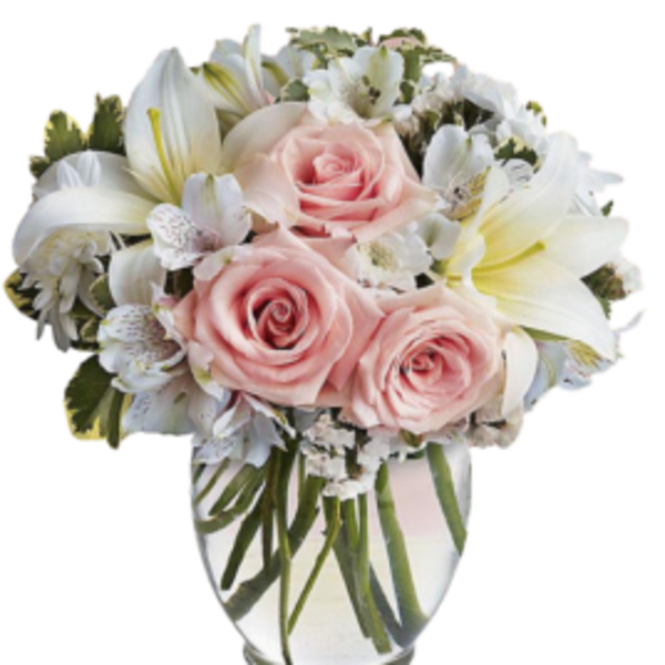 Pink roses and white lilies in a clear glass vase