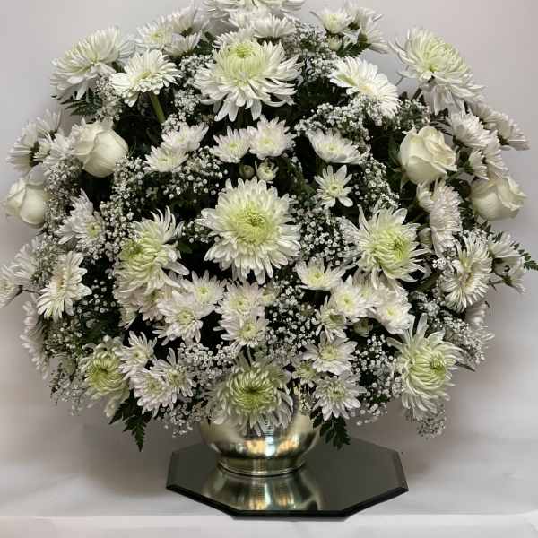 White chrysanthemum and rose arrangement in a silver vase